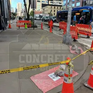 Corner sidewalk replacement protected by barricades on a busy Brooklyn street