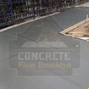 Wet concrete being finished for a new city sidewalk