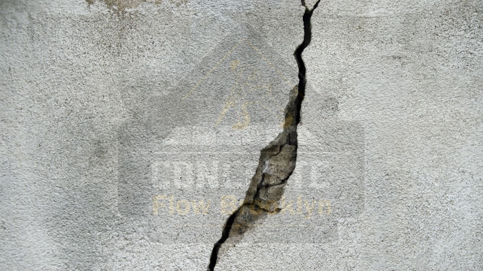 Cracked and damaged concrete showing visible signs of wear, indicating the need for concrete restoration